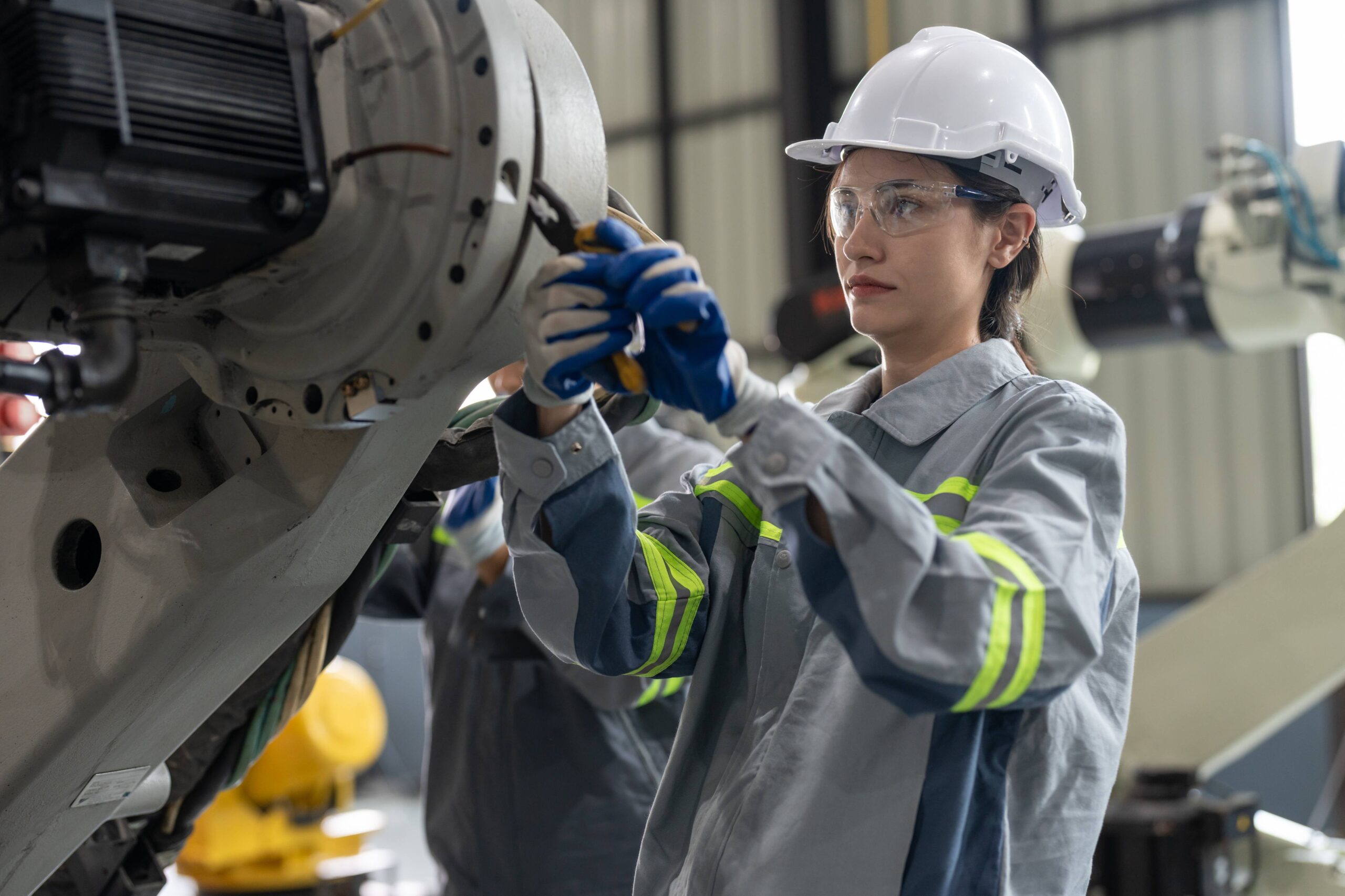 female-engineer-checking-and-maintaining-robot-arm-2025-10-08-11-31-55-utc