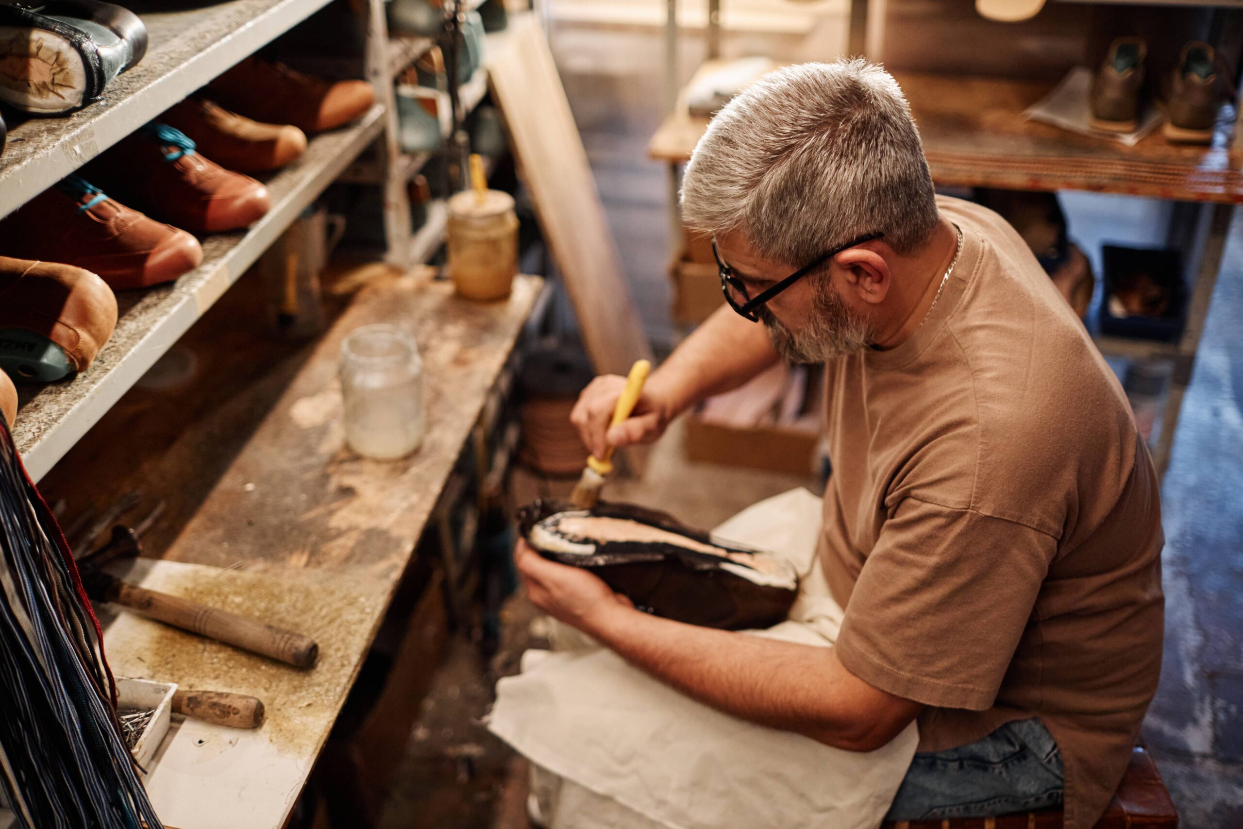 side-view-of-mature-experienced-shoemaker-spreadin-2025-02-11-15-42-23-utc