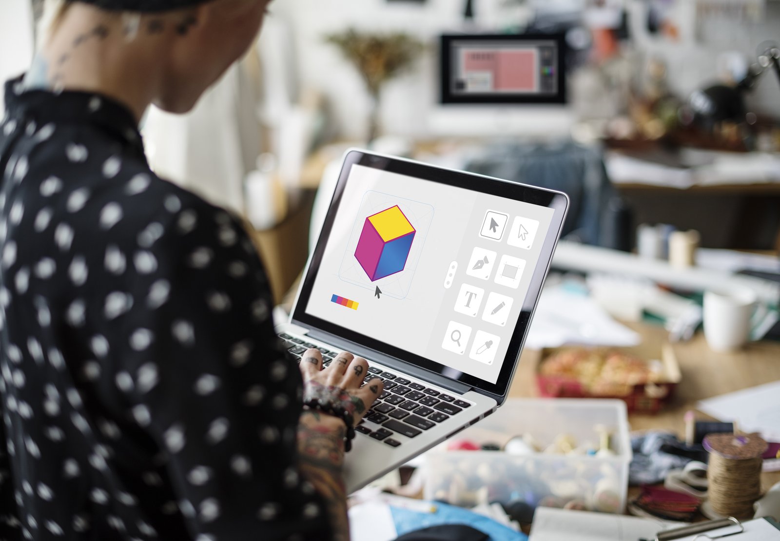 A designer working with AI-assisted graphic design software on a laptop A designer working with AI-assisted graphic design software on a laptop