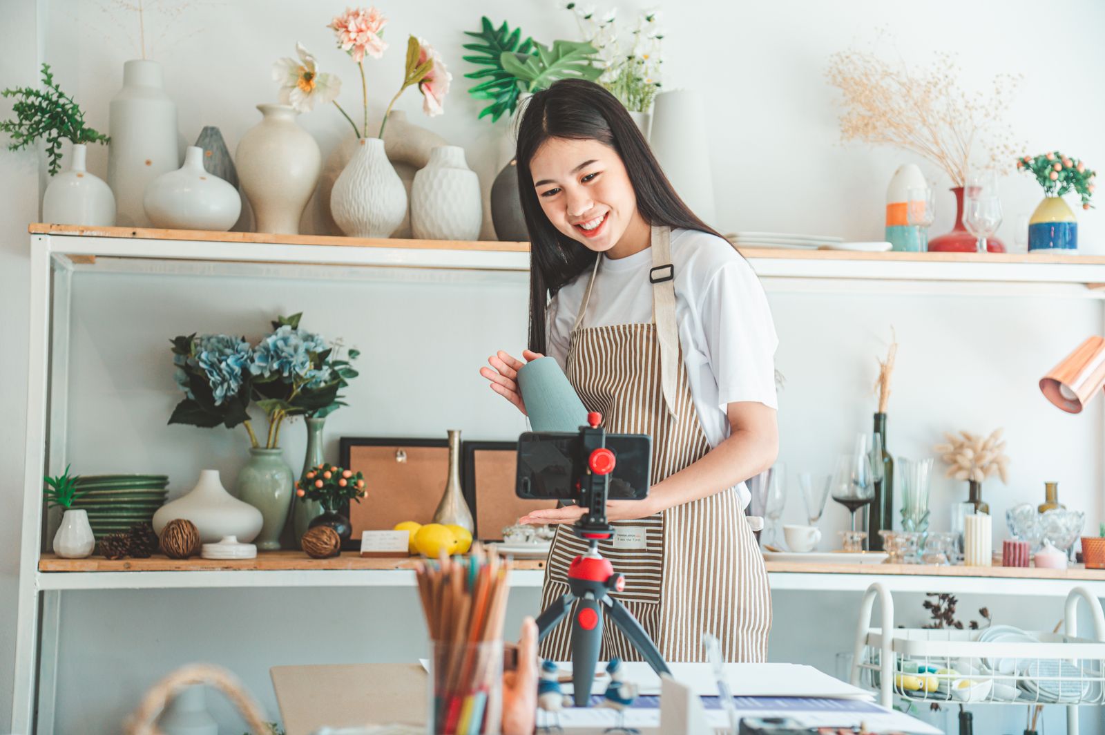 An independent ceramics artisan filming her products for an online audience An independent ceramics artisan filming her products for an online audience