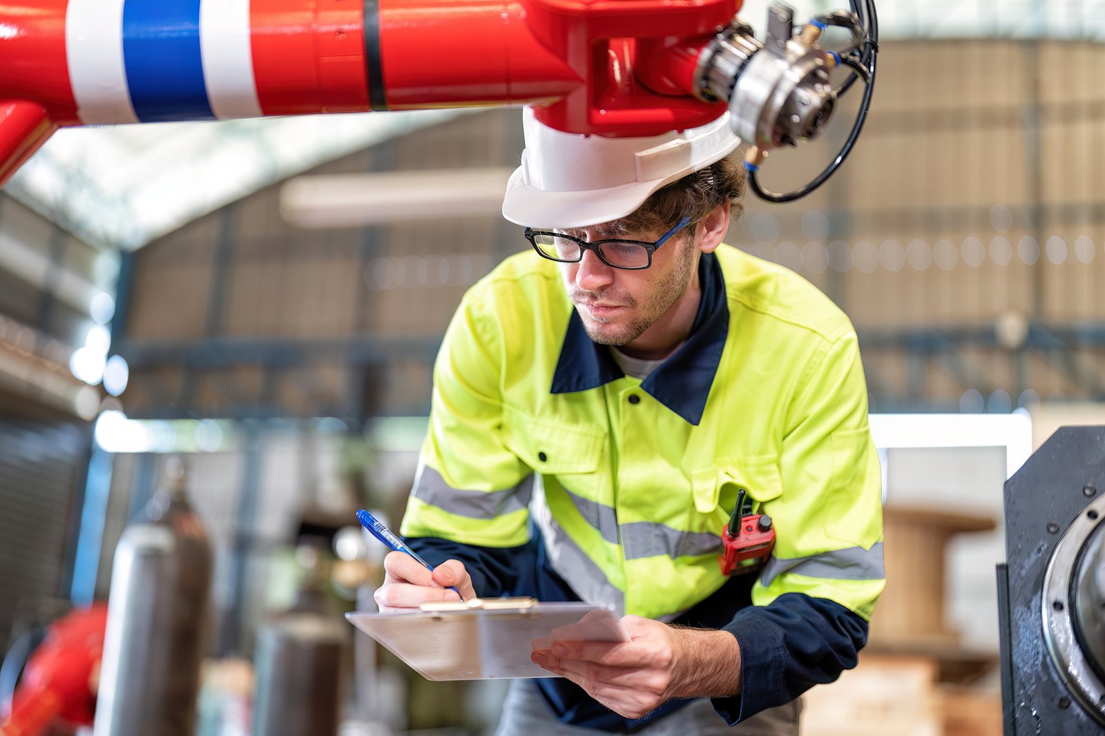 An engineer performing a quality check with a robotic arm, checking real Industry 5.0 adoption An engineer performing a quality check with a robotic arm, checking real Industry 5.0 adoption