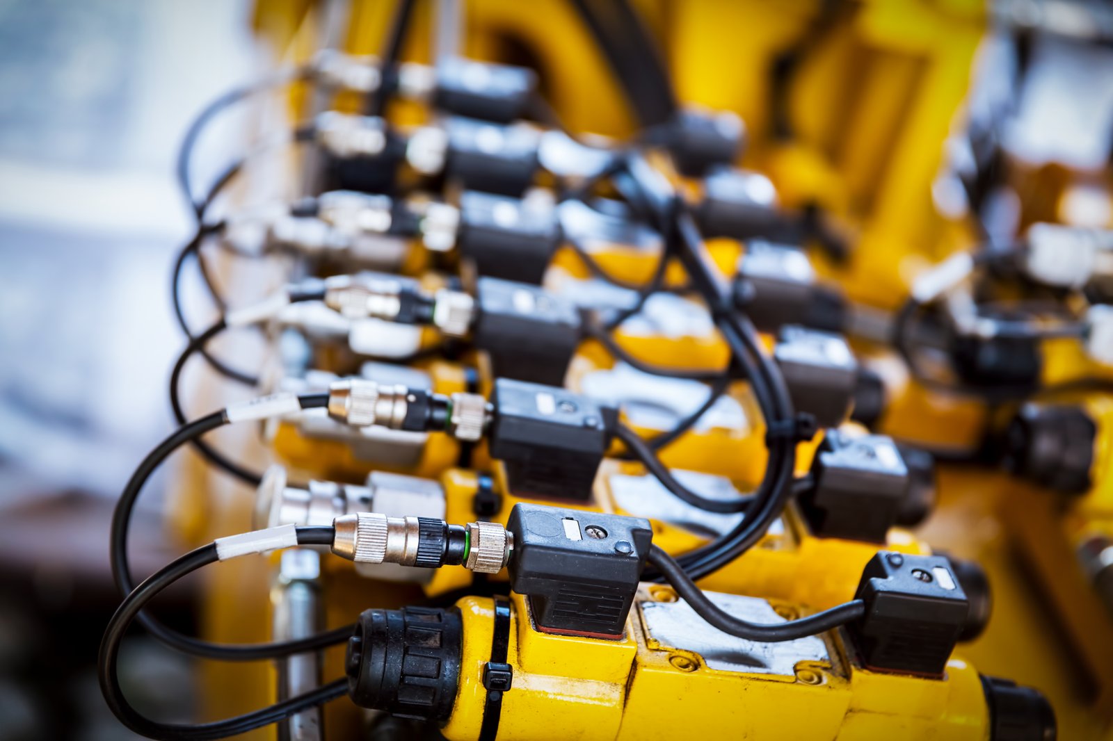 Close-up of industrial sensors and cabling, the unglamorous IoT backbone of automation Close-up of industrial sensors and cabling, the unglamorous IoT backbone of automation