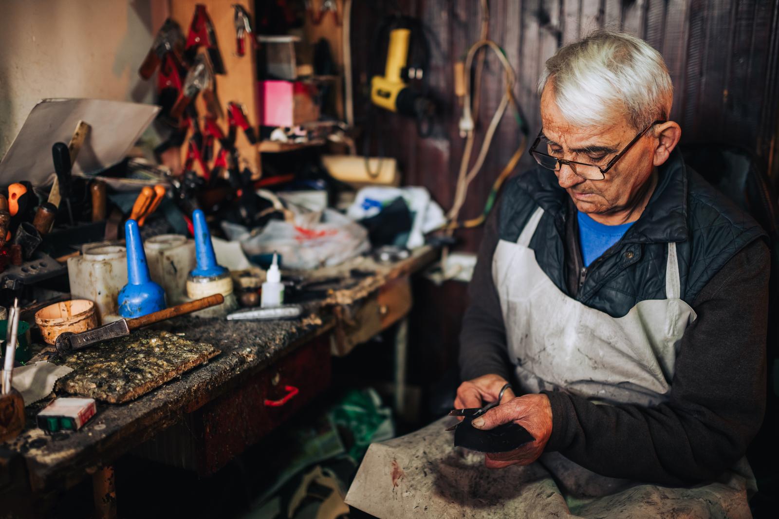 A craftsman carefully repairing an object by hand, the essence of restoration craft A craftsman carefully repairing an object by hand, the essence of restoration craft